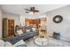Open-concept room featuring an entertainment center, glass coffee table, and view to kitchen and dining at 1108 Blackwater Dr, Wesley Chapel, FL 33543