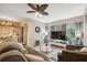 Open-concept living room boasts natural light, a large TV, and an inviting sofa at 1108 Blackwater Dr, Wesley Chapel, FL 33543