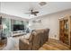 Comfortable living room with a ceiling fan, large TV, and a cozy reclining sofa at 1108 Blackwater Dr, Wesley Chapel, FL 33543