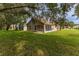 Expansive backyard featuring a well-maintained lawn and a screened-in lanai at 11158 Heathrow Ave, Spring Hill, FL 34609