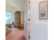 Bedroom with an arched doorway, an ornate wardrobe, and soft pink carpeting at 11158 Heathrow Ave, Spring Hill, FL 34609