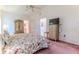Vaulted ceiling bedroom with floral bedding and an open ensuite bathroom at 11158 Heathrow Ave, Spring Hill, FL 34609