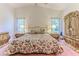Spacious bedroom featuring a large decorative bed, an ornate wardrobe, and bedside tables at 11158 Heathrow Ave, Spring Hill, FL 34609