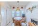 Cozy dining area with woven chairs, decorative lighting, and a bay window at 11158 Heathrow Ave, Spring Hill, FL 34609