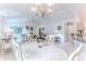 Bright and open dining room with elegant chandelier, tile flooring and sliding glass doors at 11158 Heathrow Ave, Spring Hill, FL 34609