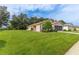 Well-maintained one-story home with a spacious lawn and mature landscaping at 11158 Heathrow Ave, Spring Hill, FL 34609