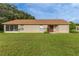 Charming one-story home boasts a well-kept lawn and a welcoming red front door at 11158 Heathrow Ave, Spring Hill, FL 34609