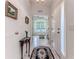 Bright and airy foyer with tile flooring, leading to the living area with ample natural light at 11158 Heathrow Ave, Spring Hill, FL 34609