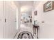 Bright foyer with white tile flooring, elegant archway, and a view of the dining and living areas at 11158 Heathrow Ave, Spring Hill, FL 34609