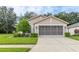 Charming single-Gathering home features a well-manicured lawn and a two-car garage in a quiet neighborhood at 11158 Heathrow Ave, Spring Hill, FL 34609