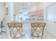 Open kitchen with bar seating and white appliances, plus white cabinetry at 11158 Heathrow Ave, Spring Hill, FL 34609