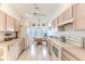 Well-lit kitchen with neutral countertops, classic appliances, and cozy breakfast nook at 11158 Heathrow Ave, Spring Hill, FL 34609