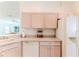 Bright kitchen featuring a white refrigerator and cabinetry, plus a dishwasher at 11158 Heathrow Ave, Spring Hill, FL 34609