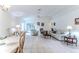 Bright living room featuring tile flooring, high ceilings, and sliding glass doors to the outdoor area at 11158 Heathrow Ave, Spring Hill, FL 34609