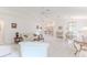 Bright open living area showcasing a modern design, tile flooring, and comfortable seating arrangements at 11158 Heathrow Ave, Spring Hill, FL 34609