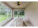 Covered patio with ceiling fan and view of the landscaped backyard and green lawn at 11158 Heathrow Ave, Spring Hill, FL 34609
