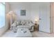 Cozy sitting room featuring a comfortable sofa, ottoman, and decorative accents at 11158 Heathrow Ave, Spring Hill, FL 34609