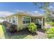 Inviting back exterior featuring a screened lanai and well-maintained landscaping with ample sunlight at 11308 Mollymawk Ct, New Port Richey, FL 34654