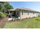 Beautiful backyard with a screened porch, grill and bright blue furniture at 11308 Mollymawk Ct, New Port Richey, FL 34654