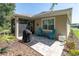 Backyard patio featuring grill, bright blue chairs and manicured landscaping at 11308 Mollymawk Ct, New Port Richey, FL 34654