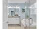 Relaxing bathroom featuring a soaking tub, glass shower, and a double vanity with granite countertops at 11308 Mollymawk Ct, New Port Richey, FL 34654
