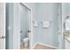 Well-lit powder room with tiled floors, a toilet and hand towel racks boasts a clean and modern aesthetic at 11308 Mollymawk Ct, New Port Richey, FL 34654