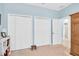Bedroom featuring three closets and neutral carpet at 11308 Mollymawk Ct, New Port Richey, FL 34654