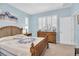 Comfortable bedroom with wooden furniture, soft lighting and window shutters creates a bright and airy feel at 11308 Mollymawk Ct, New Port Richey, FL 34654