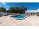 Inviting community pool with ample lounge chairs on a sunny day at 11308 Mollymawk Ct, New Port Richey, FL 34654