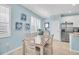 Bright dining area with window shutters and modern decor boasts a stainless steel refrigerator and plenty of natural light at 11308 Mollymawk Ct, New Port Richey, FL 34654