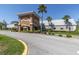 Community center exterior featuring stone accents, desert landscaping and ample parking at 11308 Mollymawk Ct, New Port Richey, FL 34654