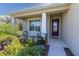 Inviting front porch with seating and decorative landscaping, creating a welcoming entrance at 11308 Mollymawk Ct, New Port Richey, FL 34654