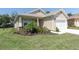 Lush front yard of a well-kept home featuring manicured lawn and colorful flowerbeds at 11308 Mollymawk Ct, New Port Richey, FL 34654