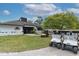 Exterior of the SummerTree Golf Club with golf carts parked outside the entrance at 11308 Mollymawk Ct, New Port Richey, FL 34654
