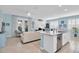 Spacious kitchen island with stainless steel appliances, seating, and an open layout to the living room at 11308 Mollymawk Ct, New Port Richey, FL 34654