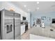 Modern kitchen featuring stainless steel appliances and granite countertops, open to the living area at 11308 Mollymawk Ct, New Port Richey, FL 34654