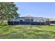 Expansive backyard with a screened-in lanai, offering outdoor living and entertaining at 11389 Mcnally Dr, Spring Hill, FL 34609