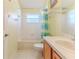 Bright bathroom featuring a shower and tub combo, tile floors, and light wood vanity at 11389 Mcnally Dr, Spring Hill, FL 34609
