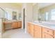 Bathroom with double vanities, tile floors, and separate tub and glass shower at 11389 Mcnally Dr, Spring Hill, FL 34609