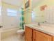 Bright bathroom featuring a shower and tub combo, tile floors, and light wood vanity at 11389 Mcnally Dr, Spring Hill, FL 34609