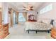 Spacious bedroom with tray ceiling, carpet, ample natural light, and patio access at 11389 Mcnally Dr, Spring Hill, FL 34609