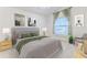 Bedroom with vaulted ceiling, ceiling fan and window staged with furniture at 11389 Mcnally Dr, Spring Hill, FL 34609