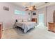Comfortable bedroom with carpet flooring, a decorative ceiling fan, and natural light at 11389 Mcnally Dr, Spring Hill, FL 34609