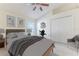 Bedroom with vaulted ceiling, ceiling fan, window and double door closet, staged with furniture at 11389 Mcnally Dr, Spring Hill, FL 34609