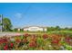 Wellington at Seven Hills entrance featuring colorful flower beds and signage at 11389 Mcnally Dr, Spring Hill, FL 34609
