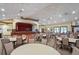 Spacious community room featuring a stage, tables, chairs, and ample lighting for various activities at 11389 Mcnally Dr, Spring Hill, FL 34609