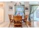 Cozy dining room with wooden table and chairs, a ceiling fan, and natural lighting at 11389 Mcnally Dr, Spring Hill, FL 34609