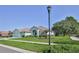 Charming one-story home with lush landscaping, decorative lamp post, and a spacious front yard at 11389 Mcnally Dr, Spring Hill, FL 34609