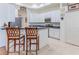 Bright kitchen with white cabinetry, a breakfast bar, and stainless-steel appliances at 11389 Mcnally Dr, Spring Hill, FL 34609
