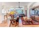 Inviting living space with wood floors, comfortable seating, and an open layout to the dining area at 11389 Mcnally Dr, Spring Hill, FL 34609